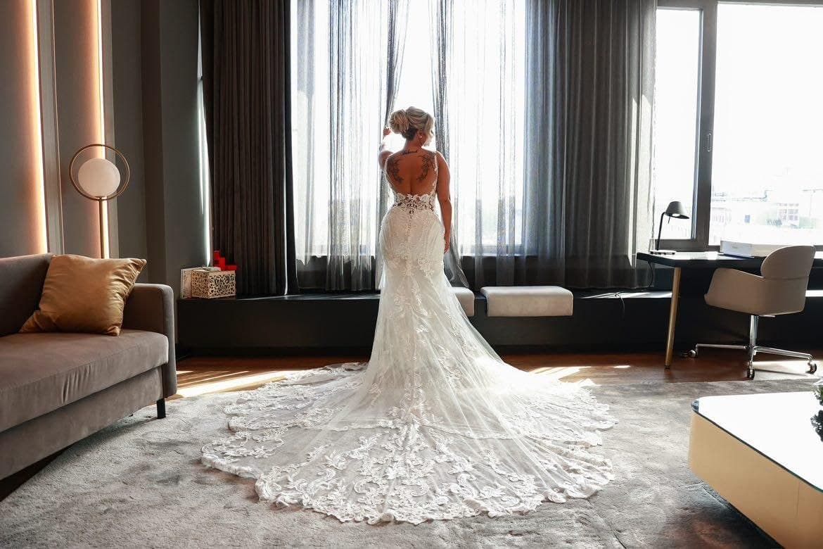 A bride by the window on her wedding day