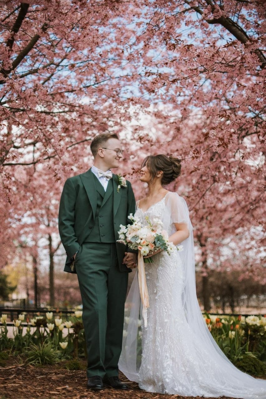 Wedding couple under cherry blossoms